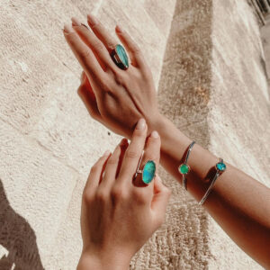 hands wearing bracelets rings amazonite chrysocolla aqua prase chalcedony